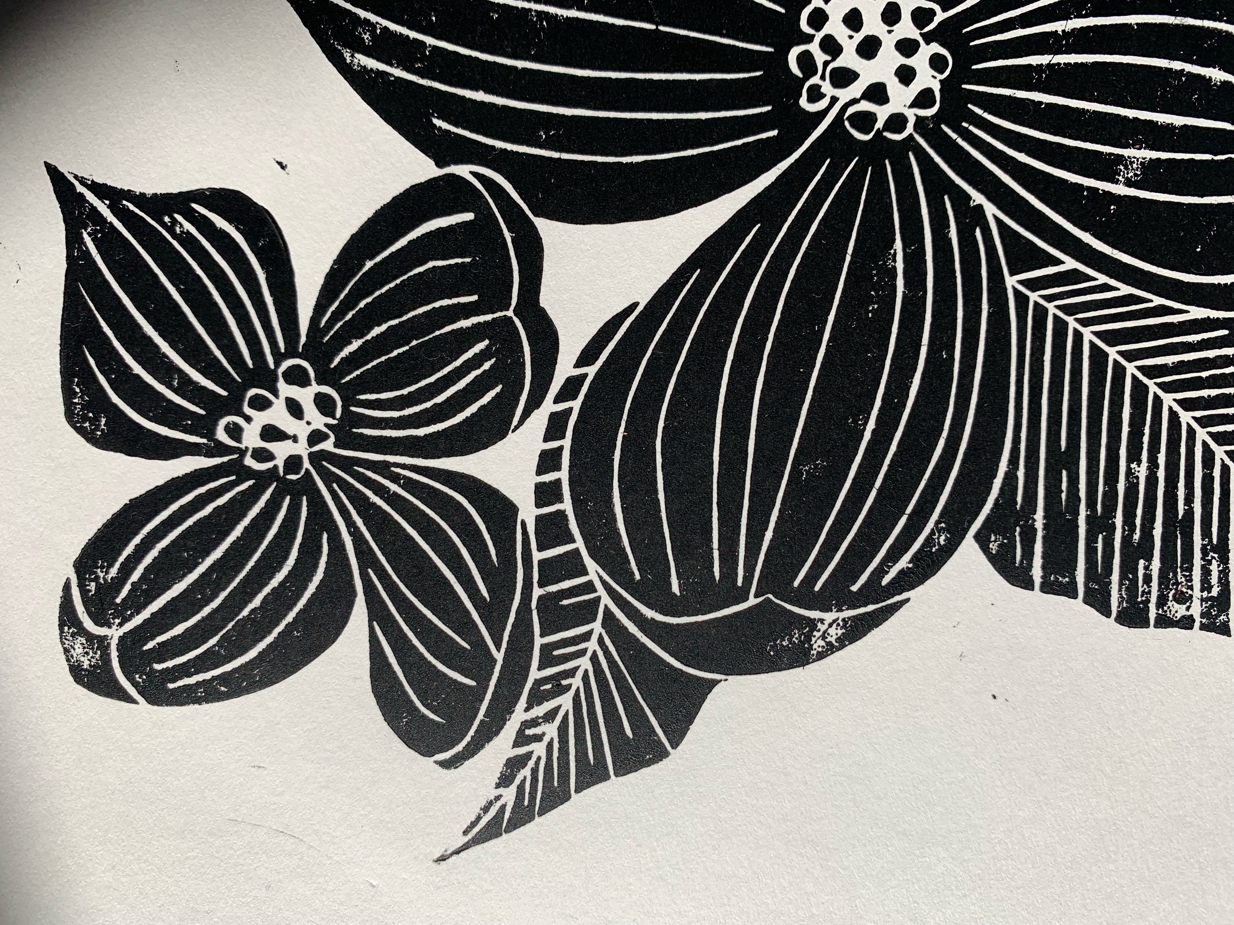 Detail of block print of Pacific dogwood in black ink on white paper.
